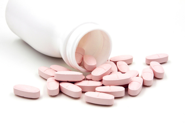 Pink pills an pill bottle on white background - Photo, Image