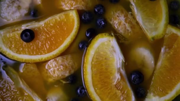 Juicy set with citrus fruits and berries. Orange, tangerine and blueberry. - Felvétel, videó