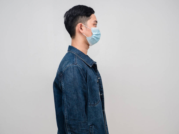 Side view young man jeans shirt wear medical mask isolated - Photo, image