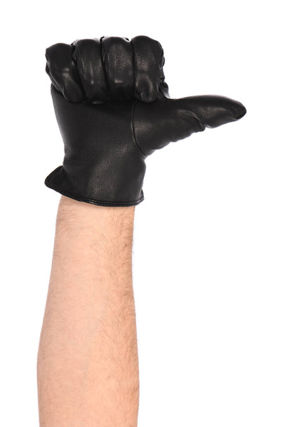 Man wearing black leather glove on white background, closeup. Thumb to the right. Side view. High resolution photo. Full depth of field. - Photo, image
