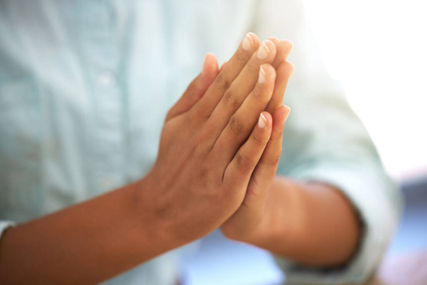 Start your day off with a prayer. an unrecognizable person sitting with their hands together - 写真・画像