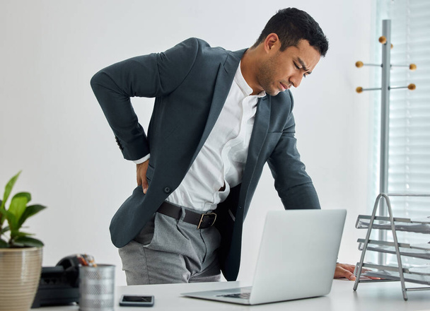 Push through the pain to get results. .shot of a businessman suffering backache in a modern office - Fotografie, Obrázek
