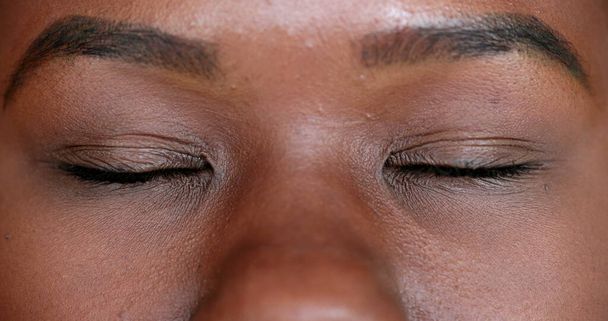 Mixed race black woman opening eyes looking at camera - Foto, Imagem