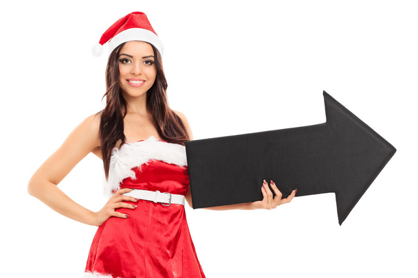 Woman in Santa costume holding arrow - Zdjęcie, obraz