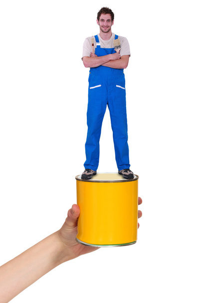 Decorator standing on a pot of paint - Foto, imagen