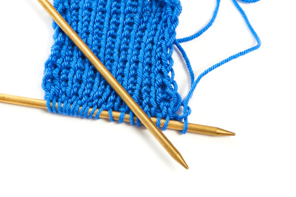 Two spokes with knit blue woolen cloth isolated macro - Foto, Imagen