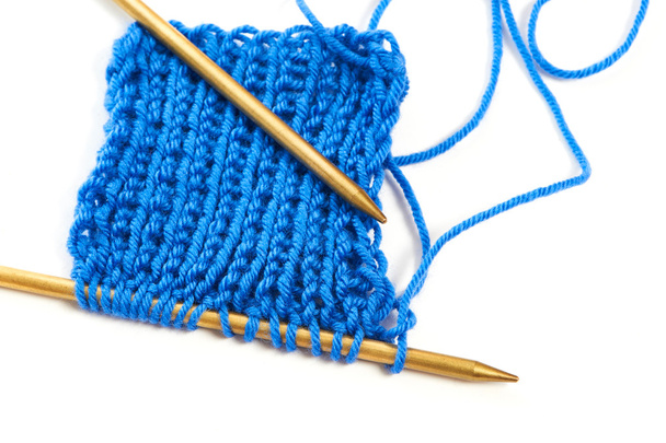 Two spokes with knit blue woolen cloth isolated macro - Zdjęcie, obraz