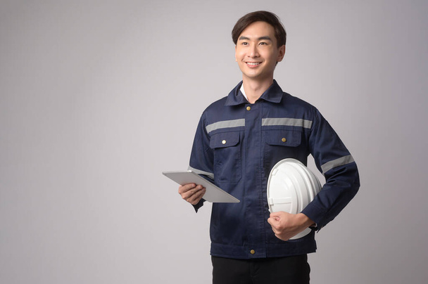A Portrait of male engineer wearing a protective helmet over white background studio. - Foto, Imagen