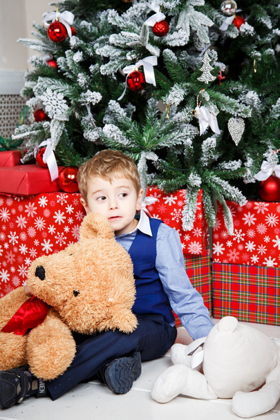 Portrait of little boy playing over christmas background - Fotoğraf, Görsel