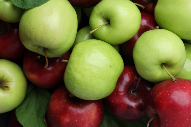 Fresh ripe green and red apples as background, top view - Photo, Image