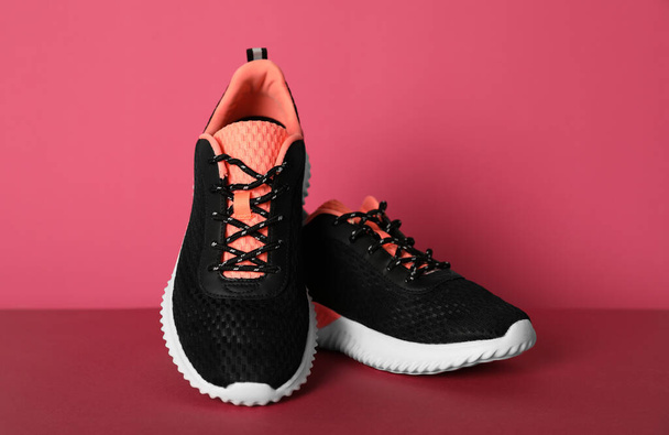 Pair of stylish sport shoes on pink background - Zdjęcie, obraz
