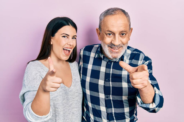 Hispanic father and daughter wearing casual clothes pointing fingers to camera with happy and funny face. good energy and vibes.  - Valokuva, kuva
