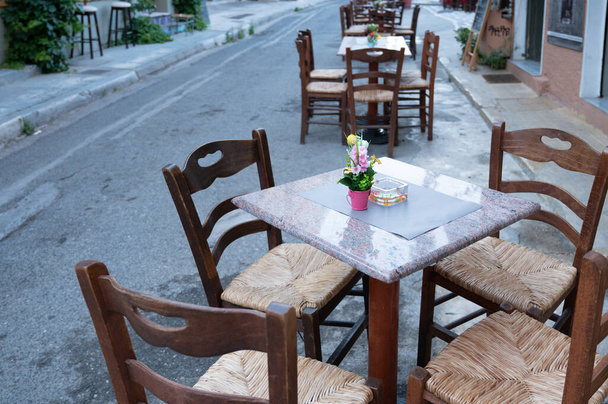 ATHENS, GREECE - MAY 14, 2022: Cafes and shops on Aristophanos street in Athens in Greece - Photo, image