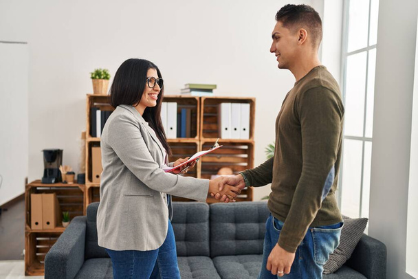 Man and woman having psychology session shake hands at clinic - Photo, Image