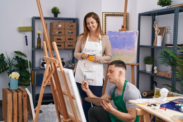 Чоловік і жінка художники п'ють малюнок кави в художній студії
 - Фото, зображення