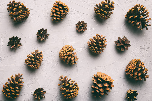 pine cones on colored table. natural holiday background with pinecones grouped together. Flat lay. Winter concept. - Photo, Image