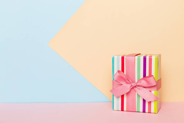 holiday paper present tied pink ribbon bow top view with copy space. Flat lay holiday background. Birthday or christmas present. Christmas gift box concept with copy space. - Фото, изображение