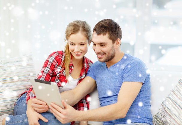 smiling couple with tablet pc computer at home - Photo, image