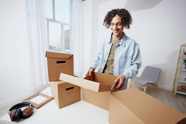 handsome guy with boxes moving Lifestyle. High quality photo - Photo, Image