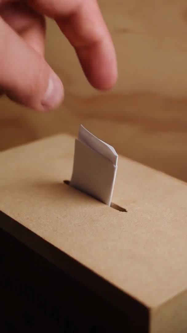 Hand casting vote in a wooden box - Filmati, video