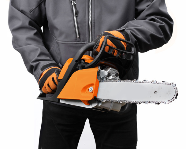 Chain saw in male workers hands - Photo, Image
