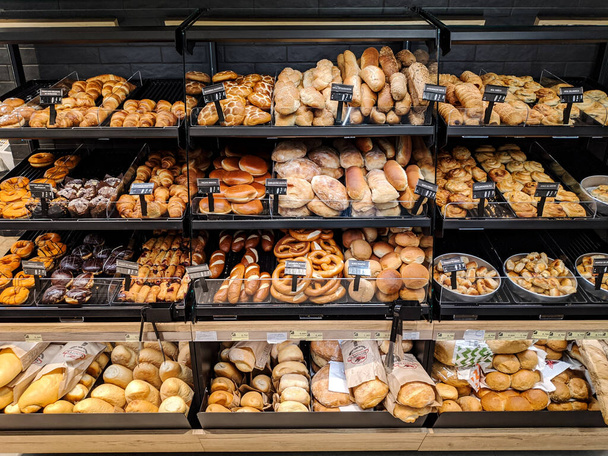 Buns, doughnuts, bagels lie on the shelves in the supermarket. High quality photo - Foto, Imagem