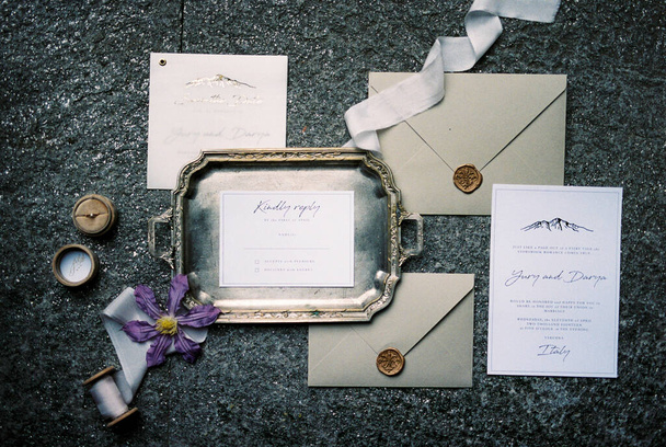 Wedding invitations lie next to envelopes and a tray. High quality photo - Fotó, kép