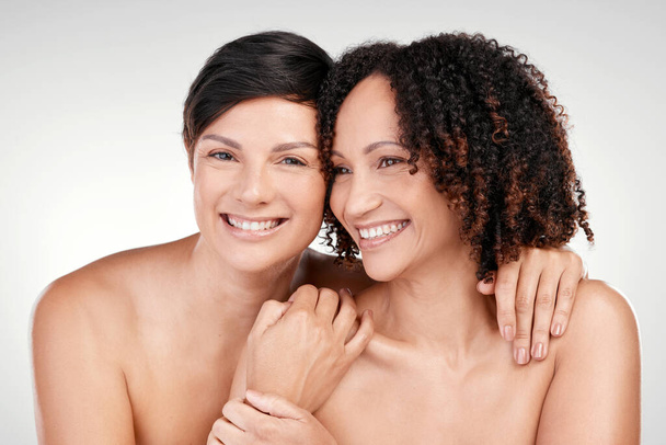 Natural beauty will always be best. two beautiful mature women posing against a grey background in studio - Fotó, kép