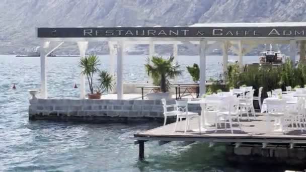 Restaurant terrace on the shore of the Kotor Bay. High quality 4k footage - Felvétel, videó