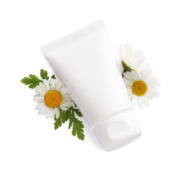 Tubes of hand cream and chamomiles on white background, top view - Foto, afbeelding