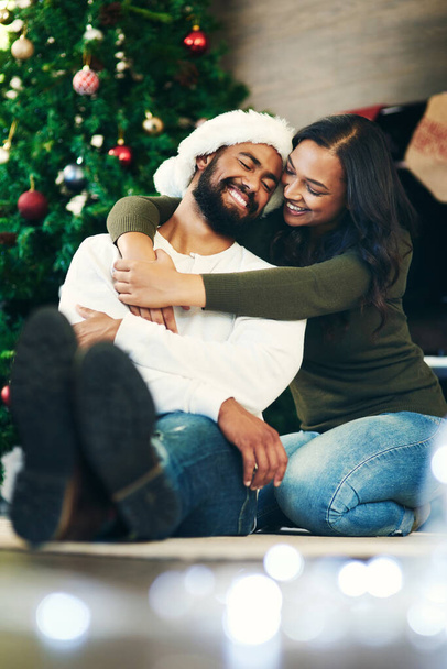 Youre always on my Christmas wish list. a happy young couple celebrating Christmas at home - 写真・画像