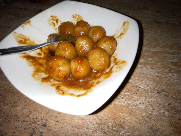 Traditional Indonesian street food called Cilok is a typical West Javanese food, made from tapioca flour and served with chilli peanut sauce shaped like meatballs - Foto, immagini