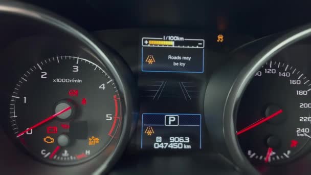 Closeup shot of a car dashboard during startup. Showing different parameters. Black and silver colours. Camera slowly zooming out. - Video