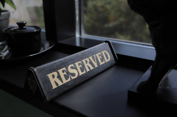 Table sign RESERVED in the restaurant. Sold out cafe concept. - Fotó, kép