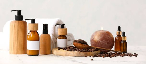 Set of bath supplies, candle and coffee beans on light background - Fotó, kép