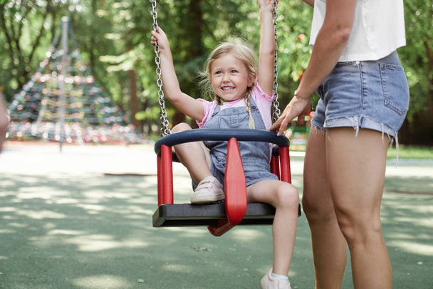 Mom spending day with daughter at playground  - Photo, Image