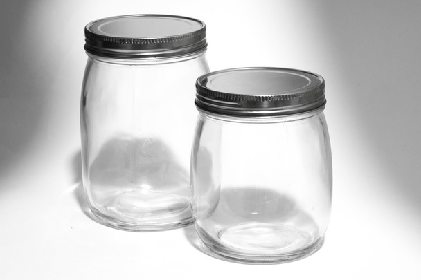 Empty glass canister in white background - Valokuva, kuva