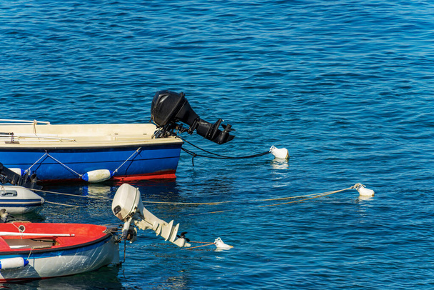 Close-up of a small group of outboard motor boats moored in the port with buoys and ropes. Gulf of La Spezia, Mediterranean Sea, Liguria, Italy, South Europe. - Φωτογραφία, εικόνα