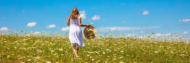 woman running in a meadow with blue sky - Фото, изображение