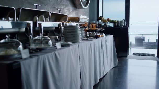 Catering buffet food table serving for business event lunch in stylish cafe bar. Luxury tablewear and delicious snacks setting in cozy hotel restaurant. Heated meal trays standing in modern cafeteria. - Filmati, video