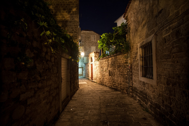 old narrow street lit by gas lanterns at night - Photo, image
