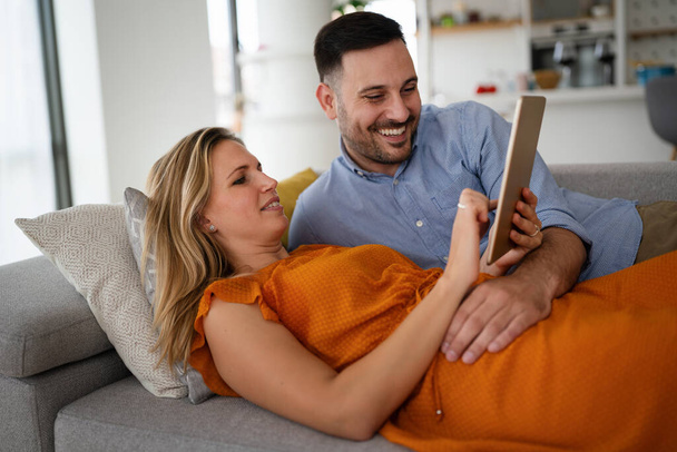 Portrait of happy young couple with tablet,watching something online. People digital device concept. - Fotografie, Obrázek