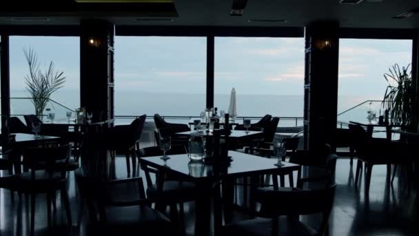 Stunning panoramic sea view in modern restaurant. Stylish interior design in luxury lounge bar background. Summer evening in cozy hotel cafe. Luxury dinner concept. - Záběry, video