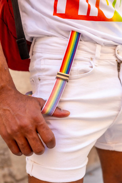 Rainbow suspenders with the hand of a gay black ethnicity man at the pride party, LGBT flag - 写真・画像
