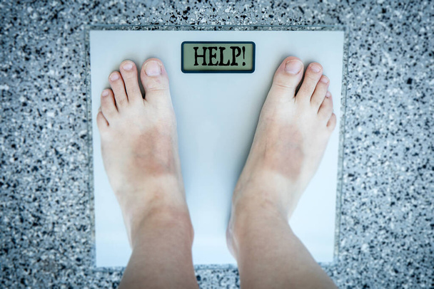 Lose weight concept. Person on a scale measuring kilogram. - 写真・画像