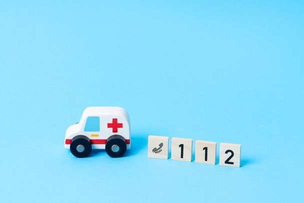 Mini toy ambulance on the signal is driving fast with help to the accident. Car crash or accident. - Foto, Imagem