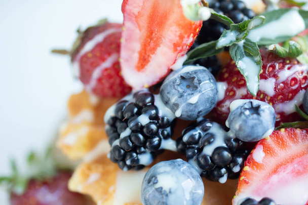 waffles with strawberry, blueberry and blackberry, mint - Fotó, kép