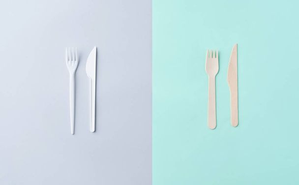 Plastic and wooden cutlery on the grey and green background. Compa - Φωτογραφία, εικόνα