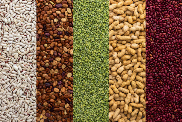 Different types of legumes, green peas and peanuts, red, white and brown beans, top view - Фото, изображение