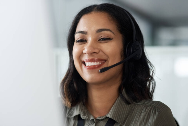 Thank you for calling us. a young businesswoman wearing a headset while working in a call centre - Foto, Imagem